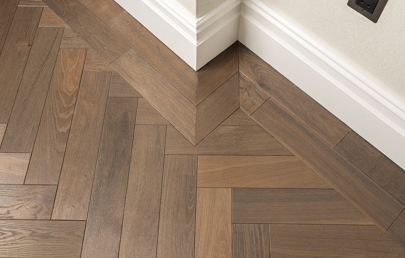 Close-up of herringbone engineered plank joinery with boarder